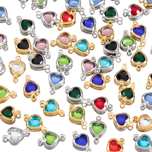 Macro shot of colorful heart-shaped crystal connectors with gold and silver metal frames