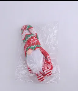 Close-up of a Christmas gnome doll with a knitted hat inside transparent packaging