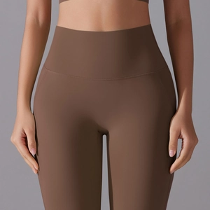 Detail of high-waisted coffee brown yoga pants with seamless waistband and ergonomic seams