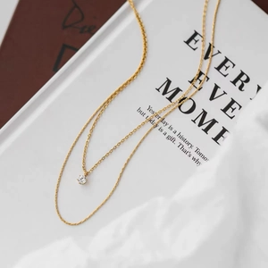 Double-layer gold stainless steel necklace featuring a minimalist round zircon pendant