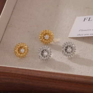 Elegant gold and silver sunflower stud earrings with sparkling crystal center stones