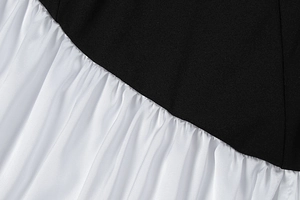Detail of high-contrast black and white patchwork fabric with delicate pleated texture