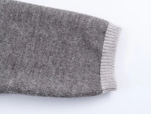 Close-up of contrast grey knit cuffs showing soft texture and premium ribbed stitching