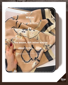 Detail of soft khaki faux cashmere scarf featuring equestrian chain print and fringe edges