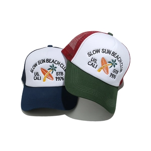 Close-up of retro trucker caps with beach club embroidery and breathable mesh texture