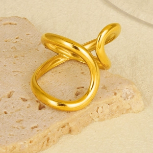 Artistic gold fluid style ring in 304 stainless steel displayed on a natural stone base
