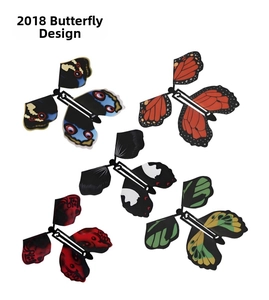 Detail of five colorful wind-up flying butterfly toys with vibrant painted wing patterns