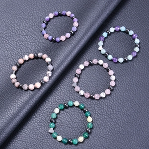 Natural agate and crystal beaded heart bracelets set on blue textured leather background