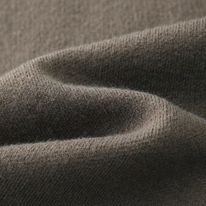 Detailed macro view of high-quality brown knit fabric texture with soft wool-like finish