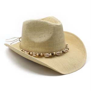 Classic straw cowboy hat with bohemian shell and bead trim decoration on white background
