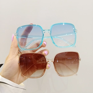 Oversized square sunglasses in sky blue and amber frames with gradient lenses