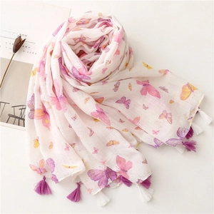 Close-up of white scarf with pink butterfly prints and decorative purple tassels