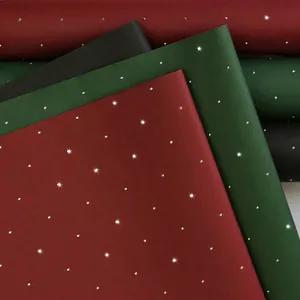 Glittering matte flower wrapping paper in dark red, forest green, and black with rhinestones