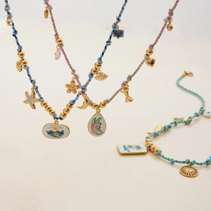 Detailed close-up of Bohemian woven necklaces and bracelets with colorful beads and charms