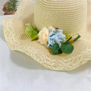 Detail of hand-woven straw hat featuring exquisite 3D floral petals and green leaves