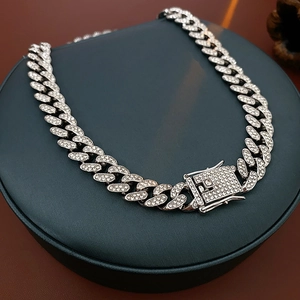Close-up of silver punk chain necklace with pavé diamonds and secure box clasp detail