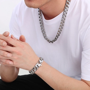 Detail of 15mm silver Cuban link chain necklace and bracelet set on a male model