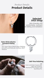 Detailed macro of S925 sterling silver hoop earrings featuring marquise-cut stone and polished finish