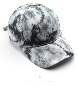 Detailed top view of black and white tie-dye baseball cap with precision stitching details