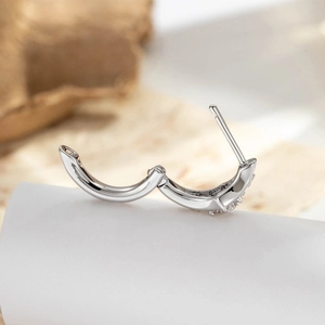 Minimalist silver star hoop earring with small sparkling zircon stones in micro view
