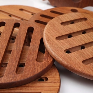 Round wooden heat-resistant pot pads with hollow drainage slots for table protection