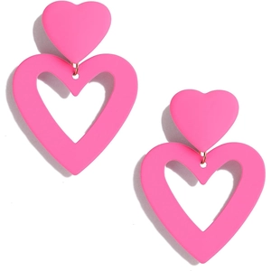 Detail of pink layered heart acrylic earrings featuring solid and hollow geometric design