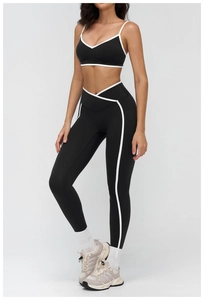 Detail of high-waist yoga pants with cross V-waistband and side stripes in black