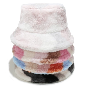 Vertical stack of mixed color plush bucket hats showing soft faux fur and thick texture