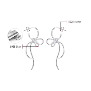 Macro view of S925 sterling silver bow knot earrings with official 925 authenticity stamp