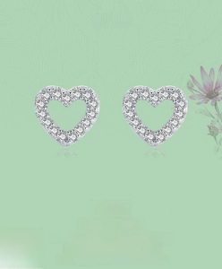 Close-up of S925 sterling silver heart stud earrings with white cubic zirconia inlay