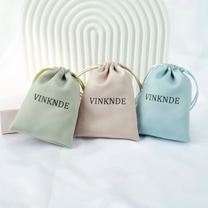 Three premium microfiber drawstring jewelry pouches in green beige and light blue colors