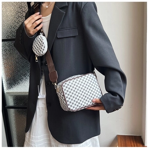Detail view of retro geometric crossbody bag with a detachable round coin purse and wide strap