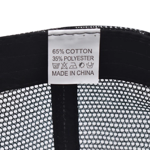 Detail of internal care label on breathable mesh cap showing 65% cotton and 35% polyester