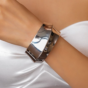 Detailed view of chunky geometric faceted silver cuff bracelet with high polish finish