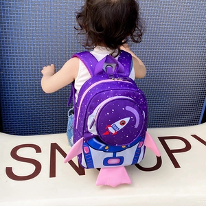 Rear view of a child wearing the purple rocket toddler backpack with safety leash