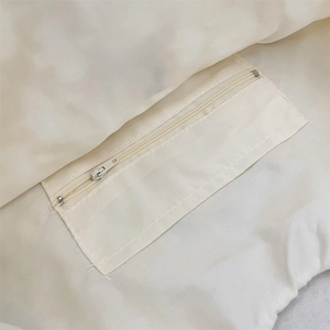 Detail of canvas tote bag interior showing a neat inner pocket with a durable zipper closure