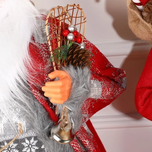 Standing Santa figurine in red jacquard coat with wooden snowshoes and pine cone details