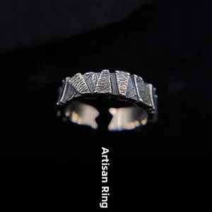Detail view of a vintage hedge textured open ring with antique silver finish and adjustable band