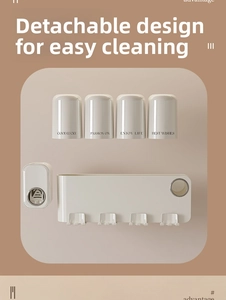 Detail of detachable cream-white toothbrush holder and cups for easy bathroom cleaning