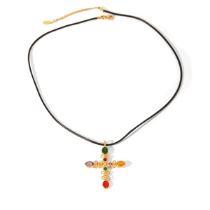 Detail of gold cross pendant with colorful oval gemstones on a black cord necklace