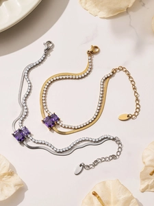 Close-up of double-layer stainless steel bracelet with square purple stones on marble