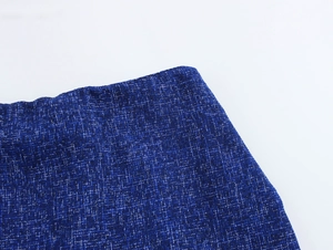 Close-up of deep blue tweed fabric with detailed woven texture and neat stitching