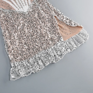 Detail of silver sequins and rhinestone trim with white lace hem on a sexy party dress