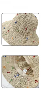 Close-up of beige paper straw hat texture with colorful embroidery and internal sweatband