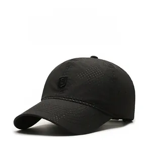 Detailed macro view of breathable perforated fabric and logo on black baseball cap