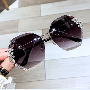 Detail of purple gradient lenses with hand-set rhinestones on frameless sunglasses