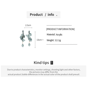 Detail view of retro acrylic petal tassel earrings in grey green with size measurements