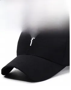 Detail of black cotton baseball cap showing white embroidery and firm brim structure
