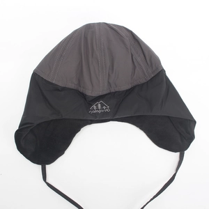 Detail of fleece-lined trapper hat with windproof fabric and embroidered mountain logo