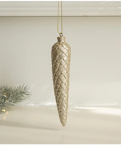 Detail of champagne gold pine cone ornament with shimmering glitter for Christmas trees
